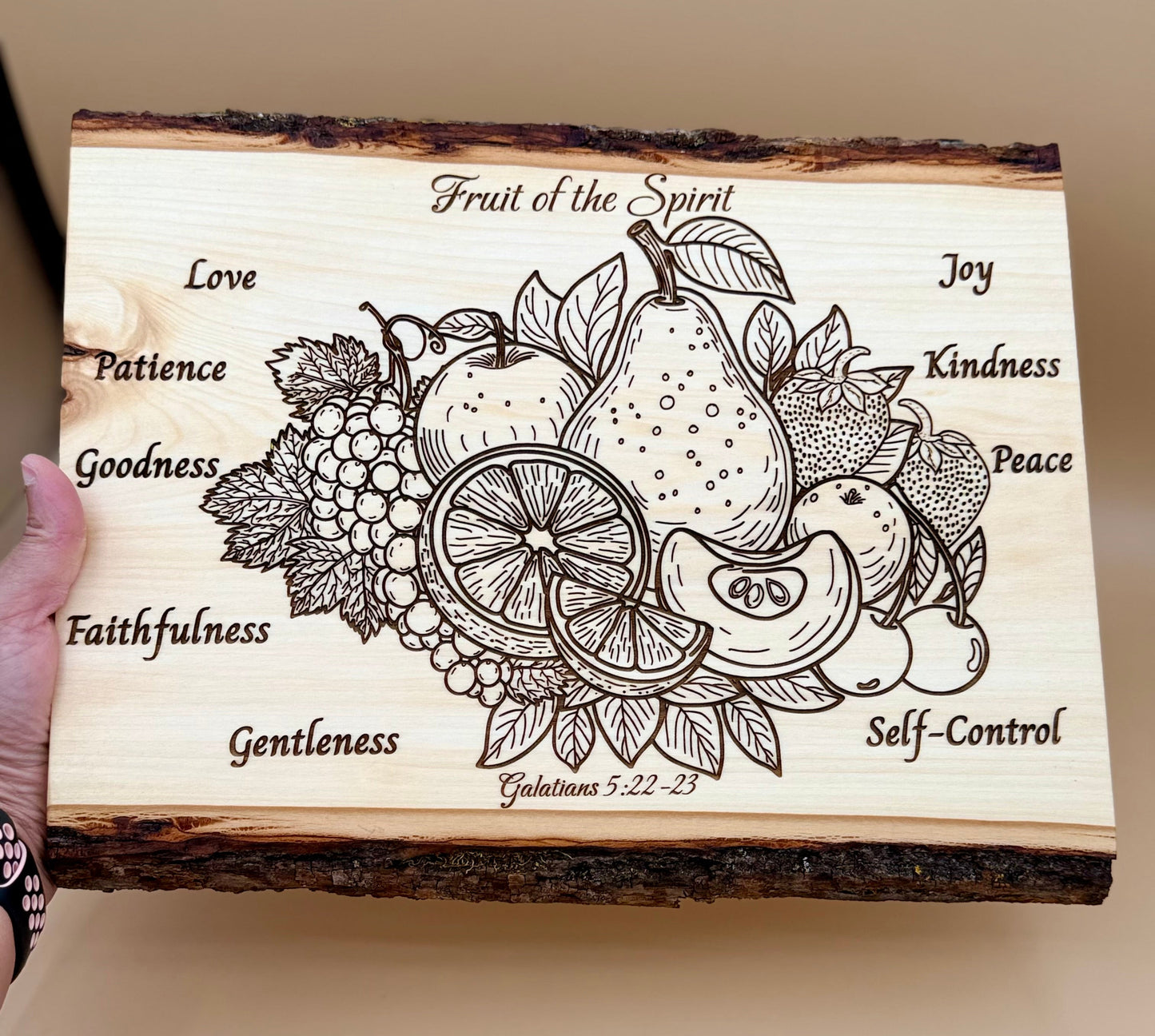 Fruit of the Spirit Live Edge Wood Plaque - Galatians 5:22-23 - Fruit of the Spirit wooden plaque featuring an engraved fruit illustration with words such as Love, Patience, Goodness, Faithfulness, Gentleness, Self-Control, Joy, Kindness, Peace.