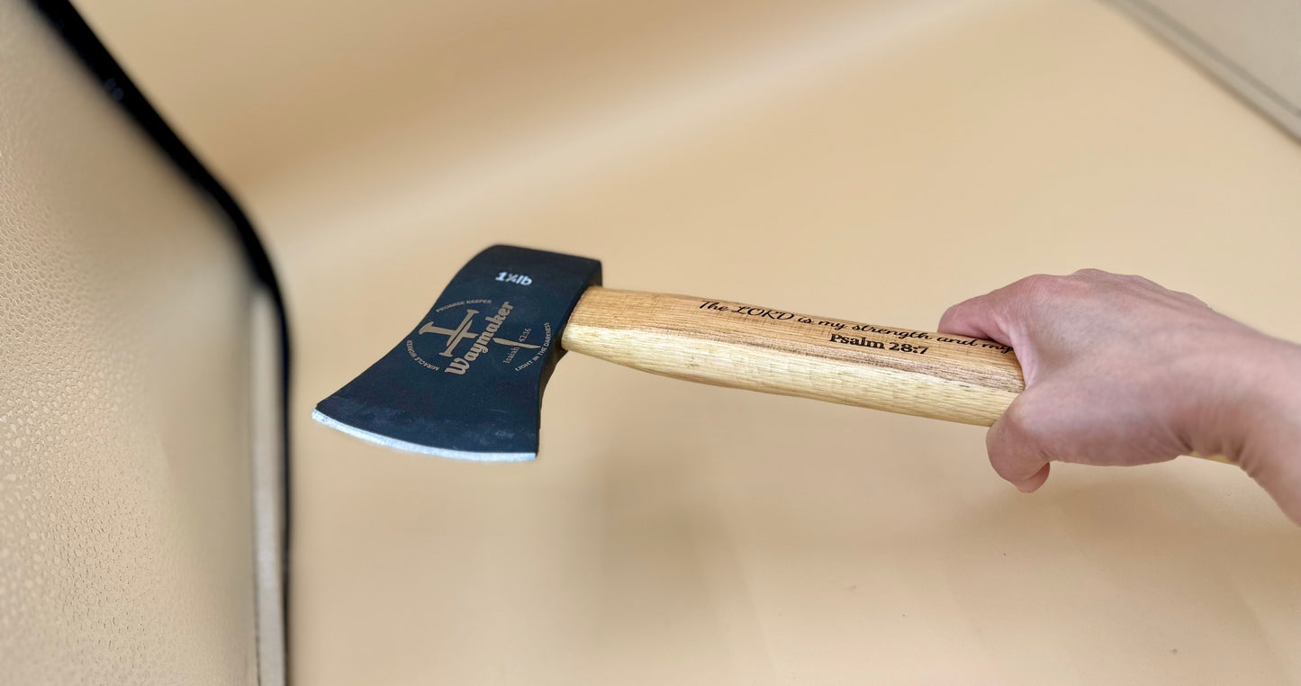 Waymaker Cross Laser Engraved Hickory Camp Hatchet (Psalm 28:7) - Handheld side view of Waymaker cross hatchet and Psalm 28:7 handle inscription — His Word Designs